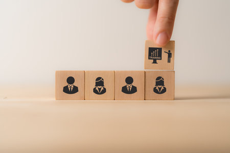 Training and knowledge sharing concept. Workforce and team training plan and management. Talent management system. Onboarding new employee process. Wooden cube blocks with training employees icon.の写真素材