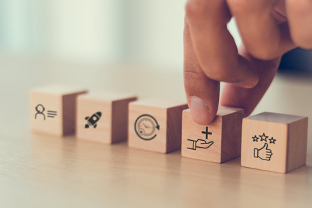 Value added concept. Way to adding value to product and service. Wooden blocks with value added icons. Improving products, excellent service, expert advice, consistently upgrade, deliver fast.の写真素材