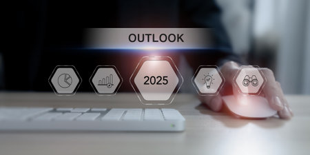 Economic, business outlook concept. Financial, business view or economic growth forecast for 2025. Businessman working on laptop with text and business trend icons on virtual screen.の写真素材