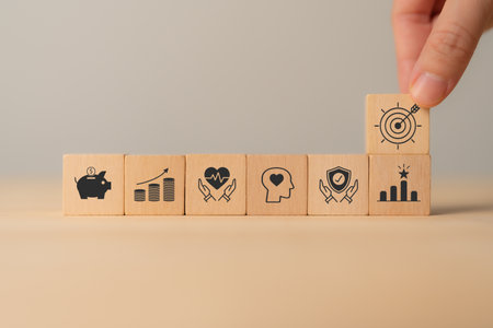 Personal goals, New year's resolutions concept. Wooden blocks with personal goal icons, copy space. Resolve to continue good practices, change behavior, accomplish a personal goal, improve behavior.の写真素材