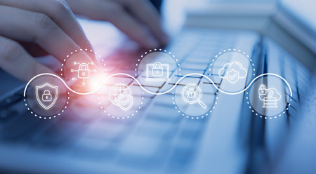 Cybersecurity concept. Hands typing on a keyboard with a digital overlay of cybersecurity icons, including locks, shields, and cloud protection, data privacy, online safety and network security.の写真素材