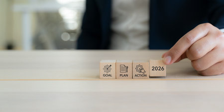 2026 Goal, plan, action, new year business strategic planning concept. Wooden blocks labeled "2026" "Goal" "Plan" and "Action" representing strategic progression toward success. Business motivation.の写真素材