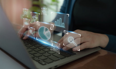 Digital marketing analytics concept. Typing on a laptop with virtual data analytics icons, including charts, graphs and search tools, digital marketing, data analysis and business intelligence.の写真素材