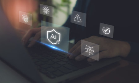 AI Cybersecurity Protection Concept. Hands typing on a laptop with digital icons; artificial intelligence, cybersecurity, data protection and warning signals, secure AI technology and online safety.の写真素材
