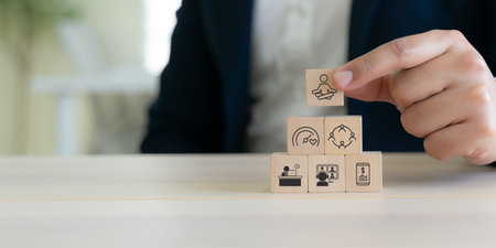 Digital wellbeing in workplace concept. Wooden blocks with icons representing digital wellbeing, healthy work-life balance. Promoting a healthy relationship with technology, encouraging mindful usage.の写真素材
