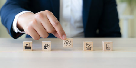 Digital wellbeing in workplace concept. Wooden blocks with icons representing digital wellbeing, healthy work-life balance. Promoting a healthy relationship with technology, encouraging mindful usage.の写真素材