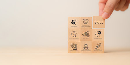 Future Skills Concept. Wooden block with skills icons critical thinking, adaptability, emotional and social intelligence and creative innovation. Digital transformation, reskilling and upskilling.の写真素材