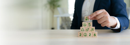 Sustainable Business Strategy Concept. Stacking wooden blocks symbolizing sustainability; carbon...