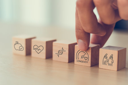 Health and longevity, longevity economy concept. Wooden blocks with icons related to health,...
