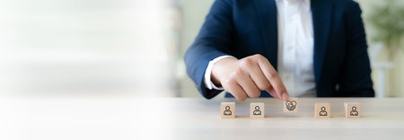 Empathy in leadership concept. Wooden block symbolizing empathy and partnership among blocks representing individuals, emotional intelligence and trust in workplace leadership and team collaboration.の写真素材