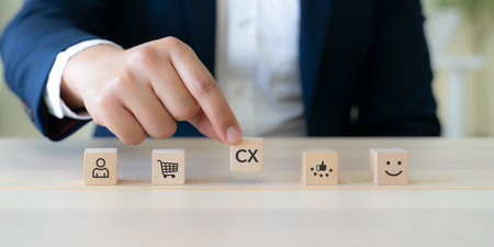 Customer Experience Strategy Concept. Wooden blocks with various stage icons of customer experience, including shopping, feedback and satisfaction. Marketing strategies and personalized engagement.の写真素材