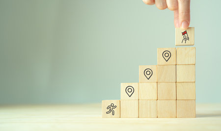 Career Path and Development Strategy Concept. Arranging wooden blocks with icons success roadmap and...