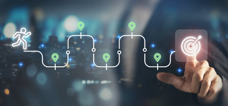 Journey to the goal , business planning concept. Touching a glowing target icon on a connected path with milestones and a running figure. Planning, progress and chievement toward business goals.の写真素材