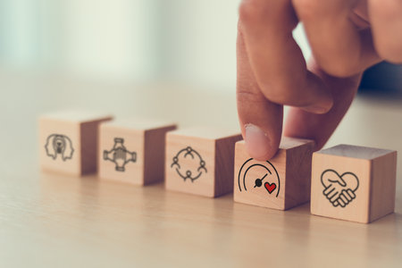 Soft skills and emotional intelligence development in leadership. Wooden blocks with soft skills icons such as empathy, communication, teamwork and emotional intelligence  in workplace.の写真素材
