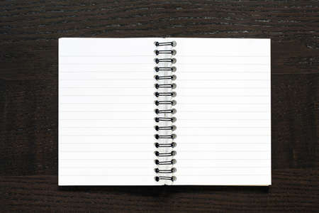 Blank notebook on dark desk