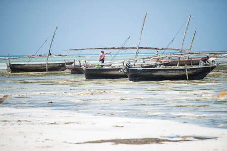 Zanzibar City, Tanzania-January 02,2019: Local fishermen are repairing their boats on the beach of Zanzibar Island.のeditorial素材