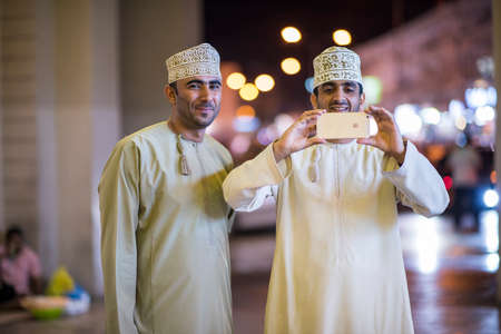 Muscat,Oman - March 05,2019 : Night views of the streets, shops and local people in various activities in the market of old town Mutrah.のeditorial素材
