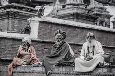 Kathmandu, Nepal- March 20,2022 : Sadhu-Indian Holymen sitting in the temple. In Hinduism, Sadhu is a common term for a mystic, an ascetic, practitioner of yoga.のeditorial素材