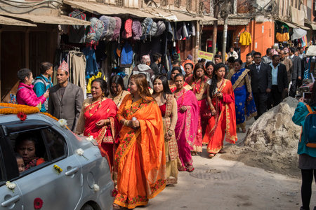 Kathmandu, Nepal- March 20,2022 : The wedding procession passes through the streets of the Patan Durbar Square with brass music and people dressed in traditional clothes.のeditorial素材