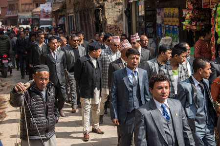 Kathmandu, Nepal- March 20,2022 : The wedding procession passes through the streets of the Patan Durbar Square with brass music and people dressed in traditional clothes.のeditorial素材