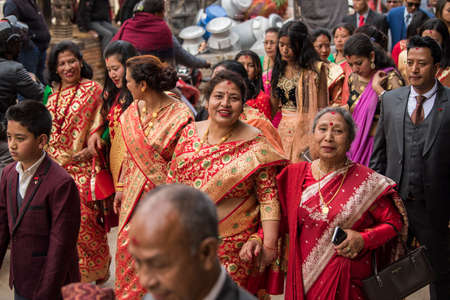 Kathmandu, Nepal- March 20,2022 : The wedding procession passes through the streets of the Patan Durbar Square with brass music and people dressed in traditional clothes.のeditorial素材