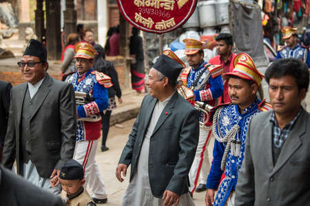 Kathmandu, Nepal- March 20,2022 : The wedding procession passes through the streets of the Patan Durbar Square with brass music and people dressed in traditional clothes.のeditorial素材