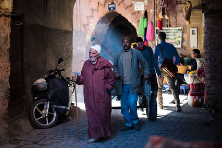 Marrakesh, Morocco -March 28, 2022: A typical street in the ancient Medina district of Marrakech. Photo contains local people doing various activities.のeditorial素材