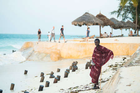 Zanzibar, Tanzania - January 02,2022: Masai warriors dressed in traditional clothes on sand beach of...