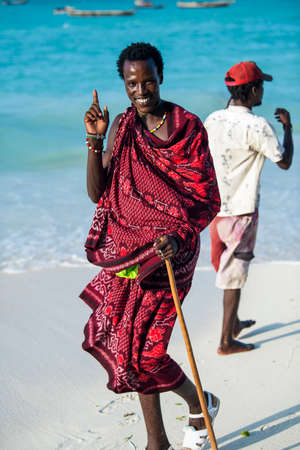 Zanzibar, Tanzania - January 02,2022: Masai warriors dressed in traditional clothes on sand beach of Zanzibar island.のeditorial素材