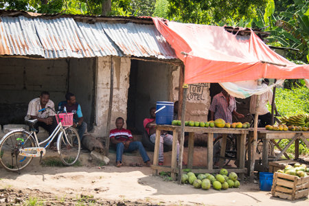 Zanzibar, Tanzania - January 05,2022: Street view of the usual daily life of local people all ages taking place along the road on the Zanzibar Island in Tanzania.のeditorial素材
