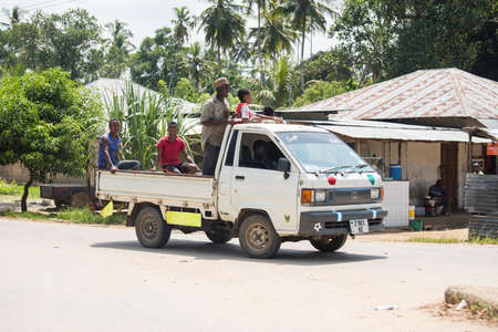 Zanzibar, Tanzania - January 05,2022: Street view of the usual daily life of local people all ages taking place along the road on the Zanzibar Island in Tanzania.のeditorial素材
