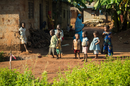Zanzibar, Tanzania - January 05,2022: Street view of the usual daily life of local people all ages taking place along the road on the Zanzibar Island in Tanzania.のeditorial素材