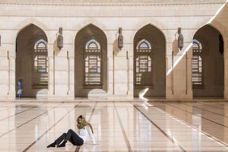 Muscat, Oman - March 05,2019 : Tourists tour in the Sultan Qaboos Grand Mosque.