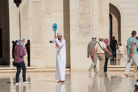Muscat, Oman - March 05,2019 : Tourists tour in the Sultan Qaboos Grand Mosque.のeditorial素材