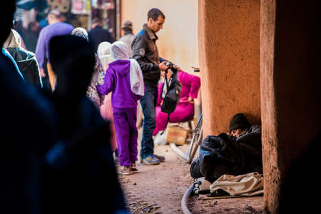 Marrakesh, Morocco - February 28, 2018: Beggars and the homeless on the streets of ancient Medina district of Marrakech.のeditorial素材