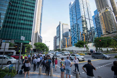 Singapore City, Singapore - September 08, 2019: At the end of the working day
office workers walking...
