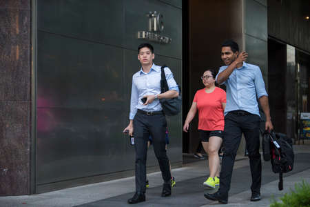 Singapore City, Singapore - September 08, 2019: At the end of the working day
office workers walking on the streets of the Central Business District.のeditorial素材