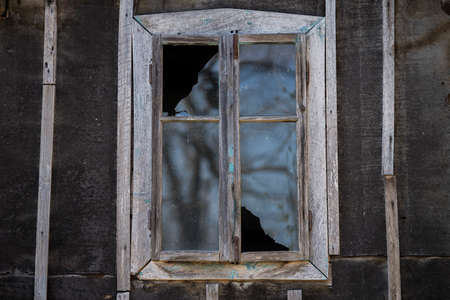 Sunja, Croatia, April 20,2021 : Rustic style aged window at rural home wall.