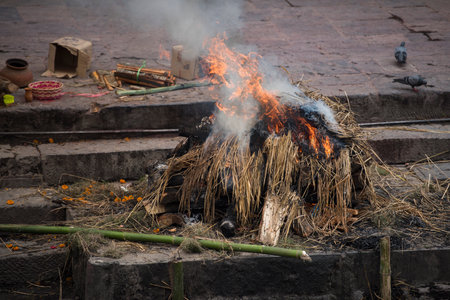 Kathmandu, Nepal- April 20,2019 : Hindu People Cremating dead bodies according to hindu rituals at...