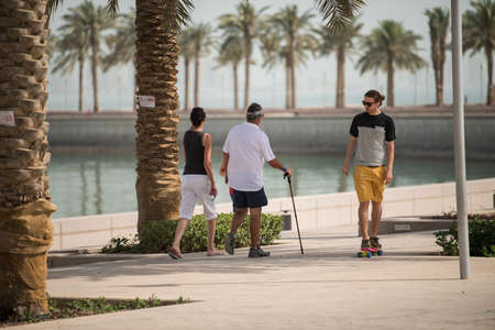 Doha,Qatar - March 05, 2020 : People enjoying a sunny day in the park of the Museum of Islamic Art in Doha.のeditorial素材