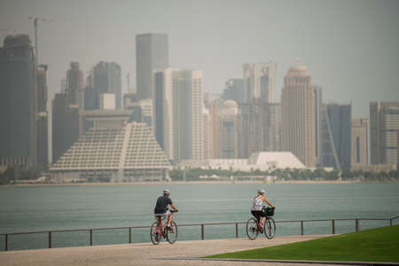 Doha,Qatar - March 05, 2020 : People enjoying a sunny day in the park of the Museum of Islamic Art in Doha.のeditorial素材