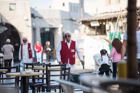 Doha, Qatar -May 25,2018: Wheel Barrow Worker in Souq Waqif, these workers are used to load goods since old traditional time.のeditorial素材