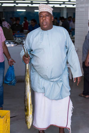 Muscat,Oman - March 05,2019 : Workers of fish market in the old town Matrah.のeditorial素材