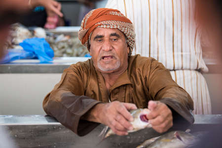 Muscat,Oman - March 05,2019 : Workers of fish market in the old town Matrah.のeditorial素材