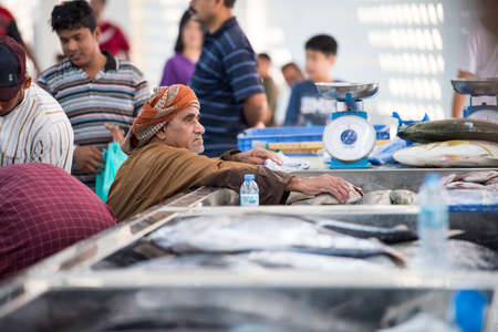 Muscat,Oman - March 05,2019 : Workers of fish market in the old town Matrah.のeditorial素材
