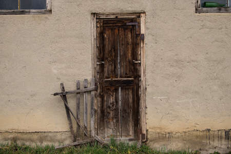 Old wooden rustic doors on rural home wall.の写真素材