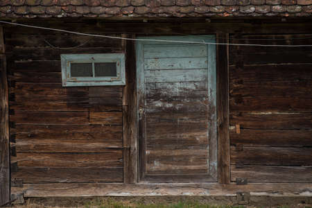 Old wooden rustic doors on rural home wall.の写真素材