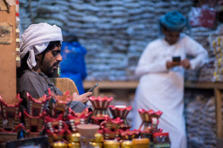 Muscat,Oman - March 05,2019 : Merchants in market shops of the old town Mutrah.のeditorial素材