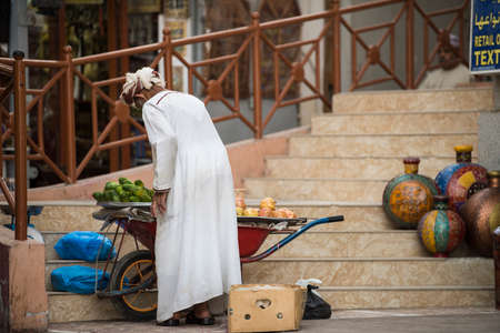 Muscat,Oman - March 05,2019 : Merchants in market shops of the old town Mutrah.のeditorial素材