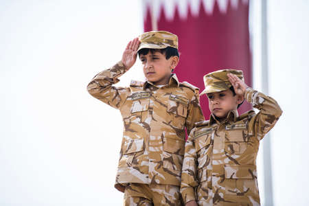 Doha, Qatar, December 18,2019. Qatari children dressed in traditional and military clothes for national day.のeditorial素材